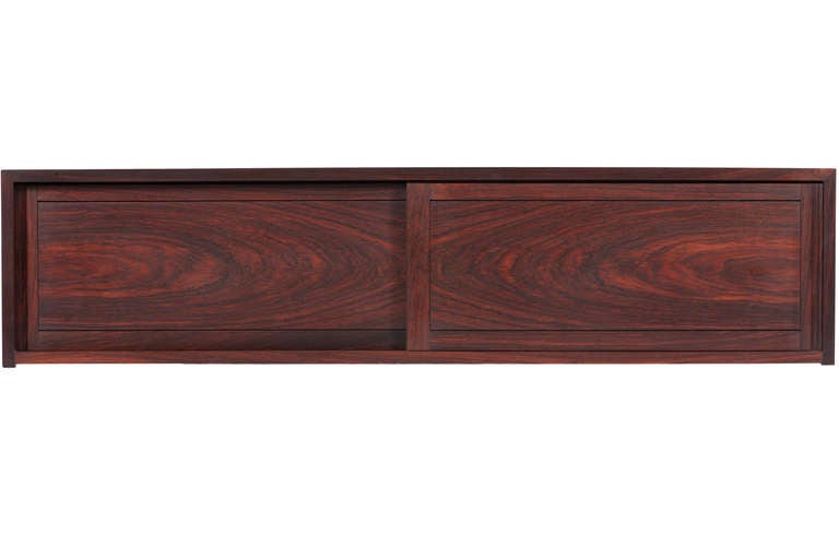 Extremely rare solid rosewood wall hanging cabinet from George Nakashima. Cabinet with 2 sliding doors and dovetailed joints to sides. Nakashima rarely worked in rosewood making this cabinet extremely uncommon. Cabinet comes with complete provenance