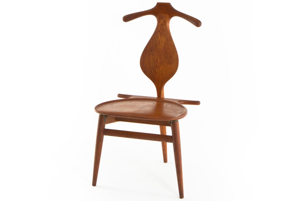Iconic,sculptural and functional designed chair from Hans Wegner and manufactured by Johannes Hansen of Denamrk. Oak chair with teak seat. Stamped to underside of chair with branded mark.