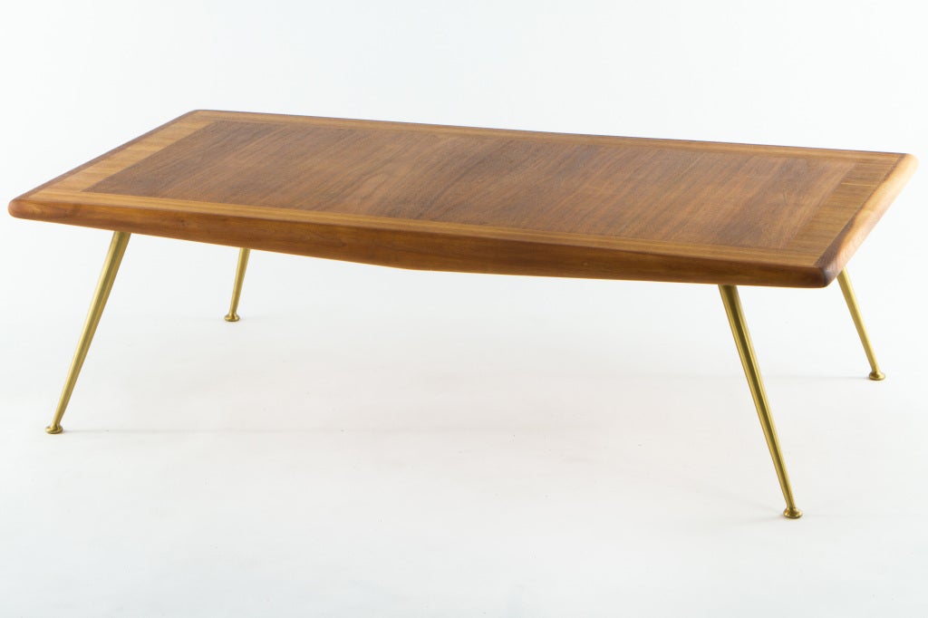 Elegant coffe table from Robsjohn-Gibbings and manufactured by Widdicomb. Mahogany top with brass legs.