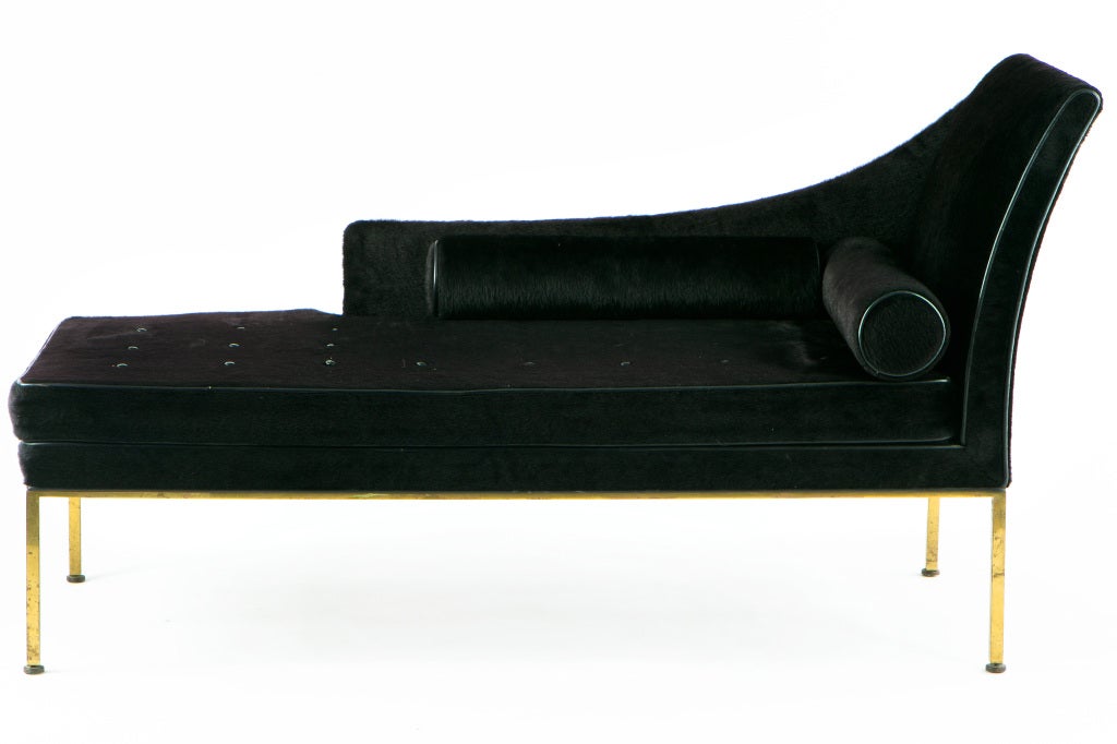 Rarely seen chaise lounge from Harvey Probber. Upholstered in faux-horsehair with leather piping, 2 bolsters and lacquered brass frame. Signed with label to underside.