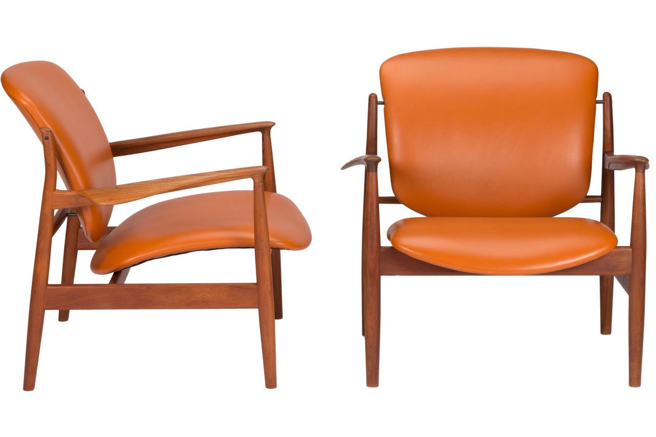 Pair of Finn Juhl lounge chairs in teak, newly and expertly reupholstered in leather.