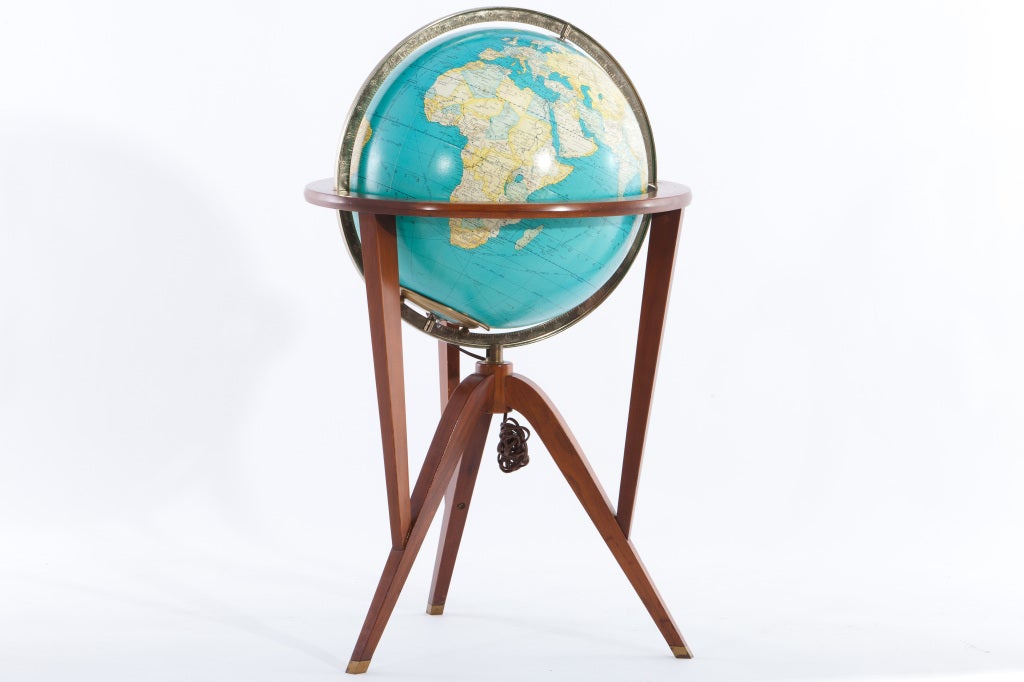 Illuminated glass globe within sculptural walnut wood frame with brass accents. Designed by Edward Wormley and manufactured by Dunbar.