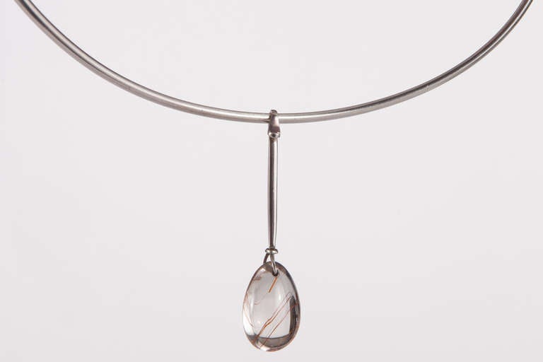 Beautiful sterling and rutilated quartz necklace designed by Vivianna Torun Bülow-Hübe and manufactured by Georg Jensen. Fully signed on neck ring and drop.