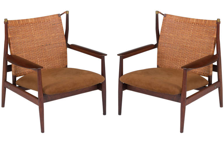 Rare pair of Walnut adjustable back armchairs designed by Finn Juhl and manufactured by Baker Furniture in the 1950's. Adjustable back, walnut arm rests and fabric seats. Chairs have had some minor restoration to frames.