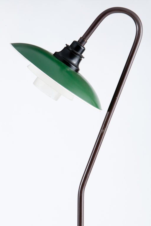 Elegant iconic floor lamp from Poul Henningsen.Signed with cast manufacturer’s mark to underside of base: [4332]. Signed with molded manufacturer’s marks to fixture: [PH Lamp Patented].