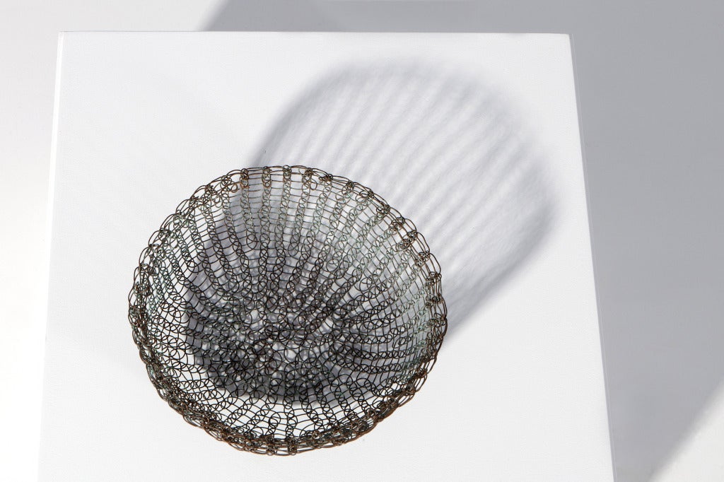 Rare and early Ruth Asawa patinated copper woven basket. Made during her time at Black Mountain College where she studied under Josef Albers and Buckminster Fuller. It was during these years that she developed her evocative crocheted wire forms.