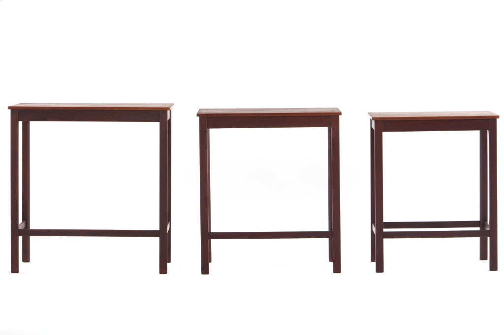 Set of 3 teak and rosewood nesting tables manufactured by Thoralds Madsens of Denmark. Finely detailed and nicely constructed. Signed with plaque to bottom.