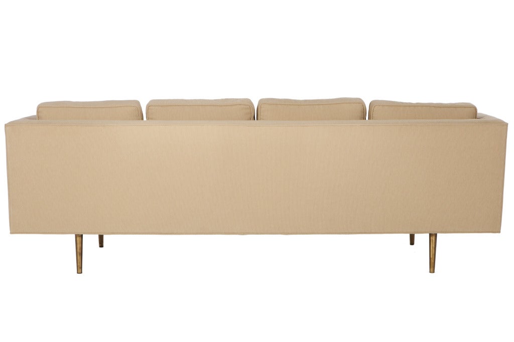 Iconic Wormley sofa model 4907 with brass legs and upholstered in Maharam fabric.