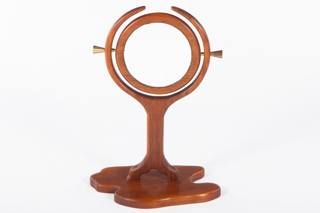 Interesting studio made mirror in the manner of Wendell Castle. Walnut sculpted base and armature. Mirror rotates on brass conical pins. Unsigned.