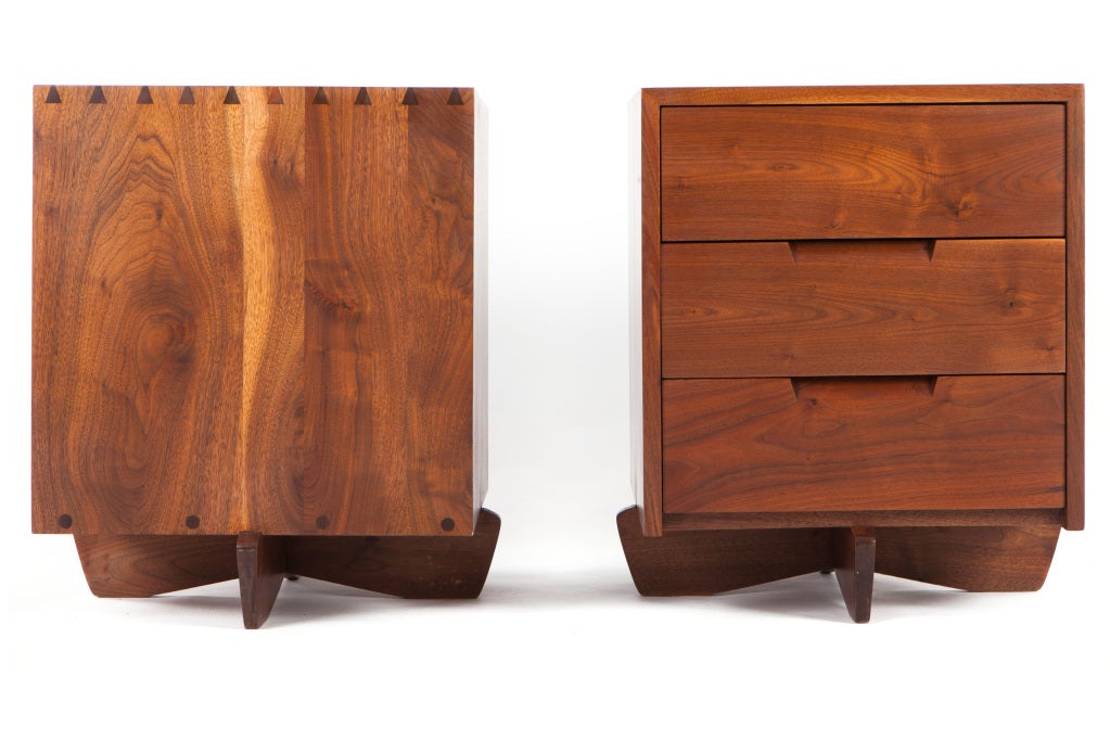 Exceedingly rare pair of walnut George Nakashima nightstands on Kornblut bases.Dovetailed joinery and 3 drawers to each cabinet. A rare and functional form.  With complete provenance.