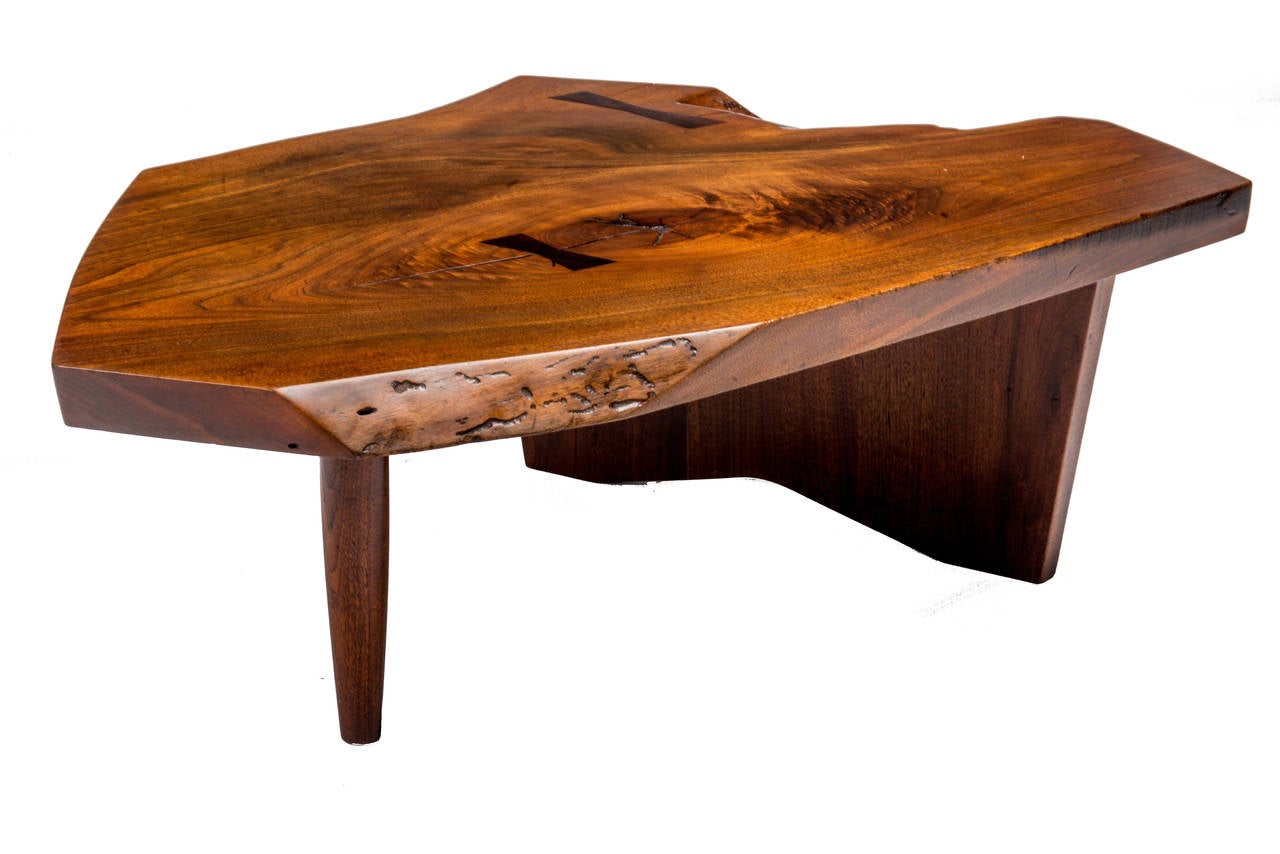 Excellent Nakashima  walnut Conoid coffee table circa 1971. Very expressive thick top with 2 large rosewood butterflies, free edges, knots and fissures. Full provenace included.