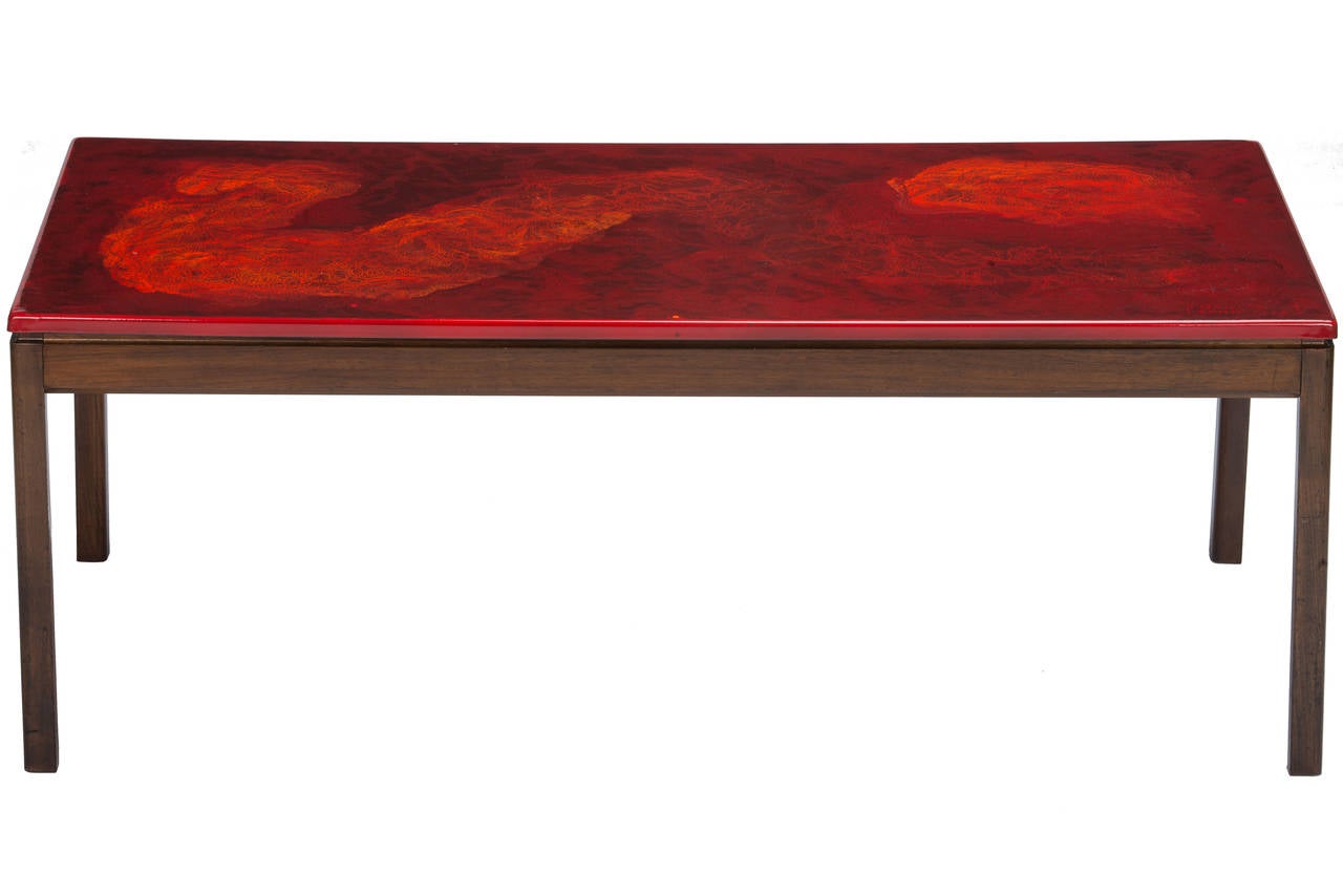Interesting enameled top coffee table by P. Torneman and David Rosen for Nordiska Kompaniet, circa 1970. Red enameled top in a very abstract painterly fashion by Algot P. Torneman atop a teak base designed by David Rosen. Signed and numbered 22/200.