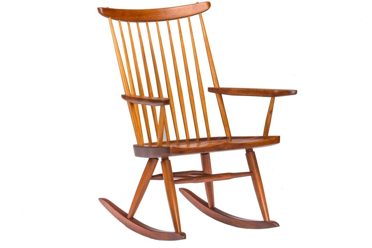 Beautiful Nakashima rocking chair with arms. Walnut chair with hickory spindles. Circa 1987 and faintly signed with client name. Chair comes with complete provenance including copy of original invoice and order card.