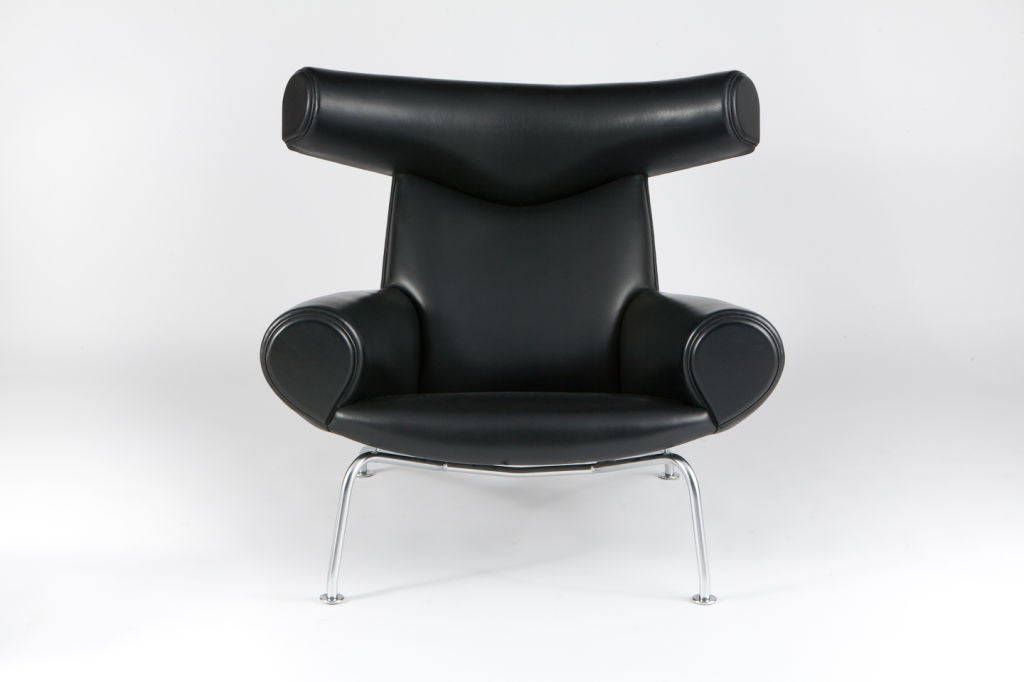Black leather Ox chair with ottoman. Designed and manufactured by AP Stolen in 1960. This example manufactured by Erik Jorgensen within the last 20 years. Ap Stolen's production of  the Ox chair was discontinued in 1962 and Erik Jorgesen became the
