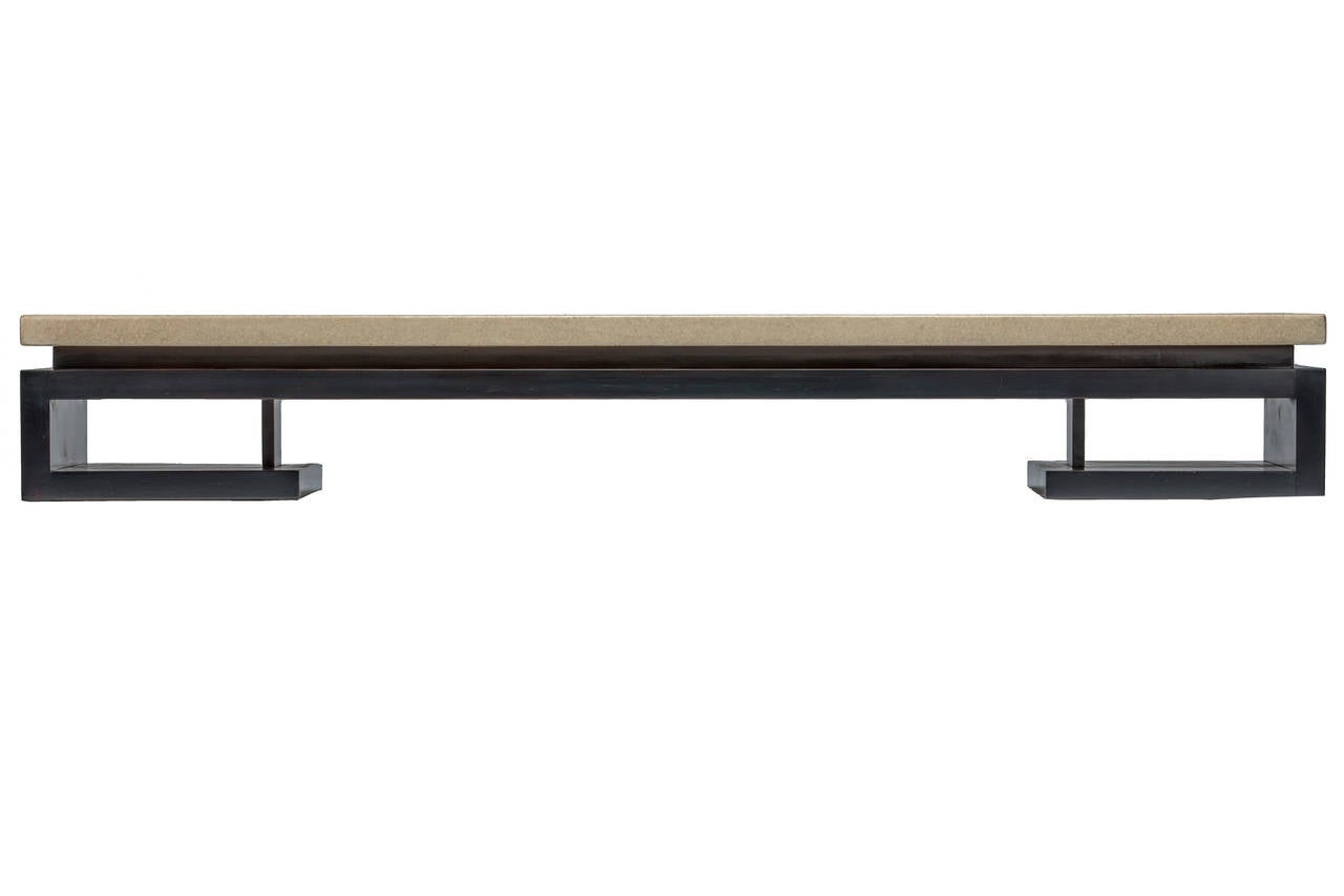 Paul Frankl designed coffee table or bench for Johnson Furniture Company, circa 1940s. Sculpted solid mahogany Greek key motif base with a floating lacquered cork top.