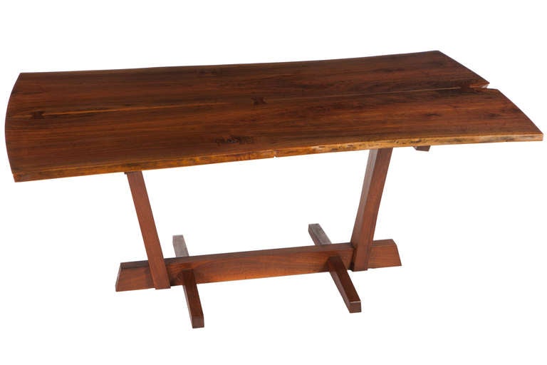 George Nakashima Conoid Dining Table c. 1971. Table with 3 rosewood butterflies on a book-matched top, conoid base and expressive free edges. Table sold with copies of original drawing and receipt.