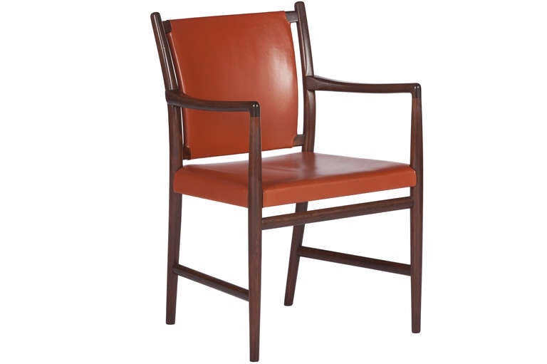 Elegant set of 7,yes 7,custom ordered dining chairs in beautiful red/brown leather from Jacob kjaer.Six sides and one arm. Chairs in mahogany with a rosewood stain. Complete with original correspondence between client and manufacturer stating that 7