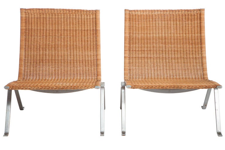 A pair of Poul Kjaerholm PK22 side chairs with frame of steel, seat and back and original wicker. Designed by Poul Kjaerholm in 1955, manufactured and stamped by E. Kold Christensen, Denmark. Chair frames with some minor pitting and loss.Caning is