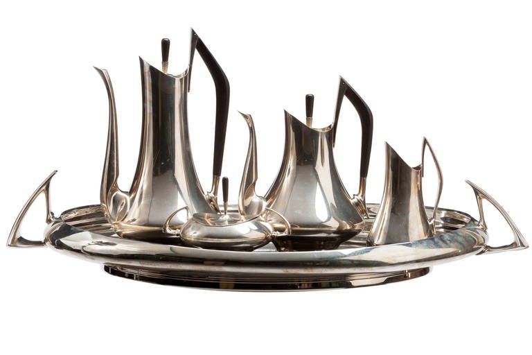 Iconic, circa 1970 Modernist Sterling coffee and tea set by Donald Colflesh, Designed and manufactured by Gorham in 1958. Sterling silver and ebony, five piece set includes coffeepot, teapot, creamer, sugar and tray. Signed and fully marked.