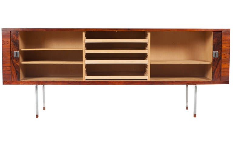 Expressively grained rosewood cabinet features two tamboured doors concealing a soaped oak interior with three compartments with four drawers and two adjustable shelves. Steel legs with rosewood caps. Designed by Hans Wegner and manufactured by Ry