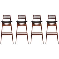 Four Rosewood and Leather Bar Stools