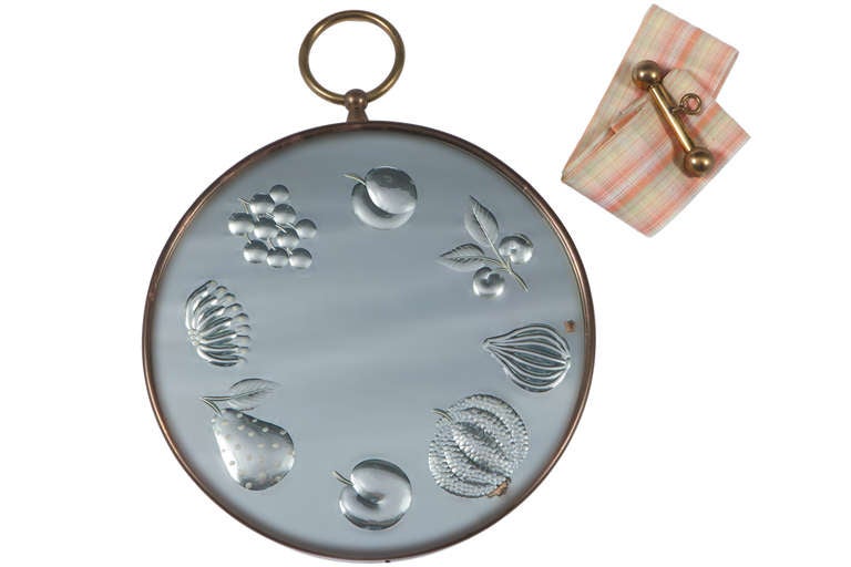 Cut glass Fornasetti mirror with a fruit motif.  With original ribbon and hanging mount.  Signed to the back.  Area of small loss to mirror backing.