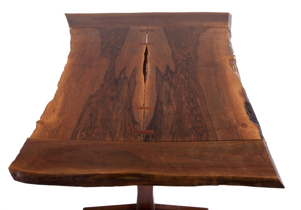 Beautiful George Nakashima dining table with finely grained, bookmatched free edge Persian walnut top with four rosewood butterflies, with two 12-inch leaves. Table has full provenance with copy of original drawing and receipt.