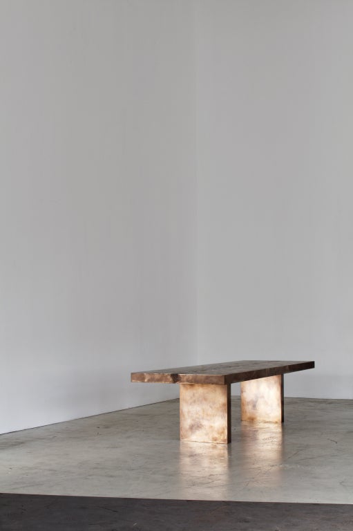 Monolithic dining table finished in our bronze metal with stingray texture and black resin backbone.