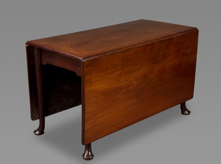 A generous sized rectangular gate-leg drop-leaf table of very well figured dense and heavy mahogany, the legs terminating in pad feet.