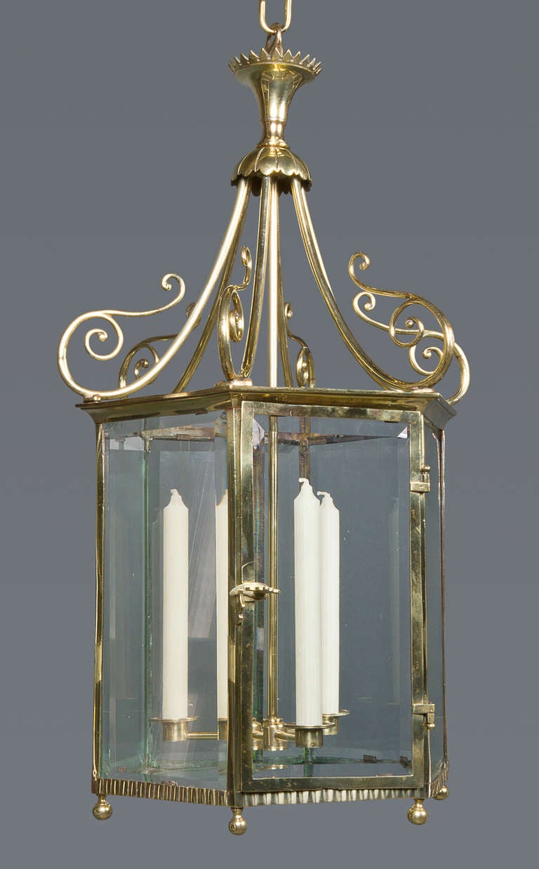 A lantern that has not been converted to electricity, this is a highly decorative and rare survival retaining its original three candle sconces and much of the original glass.