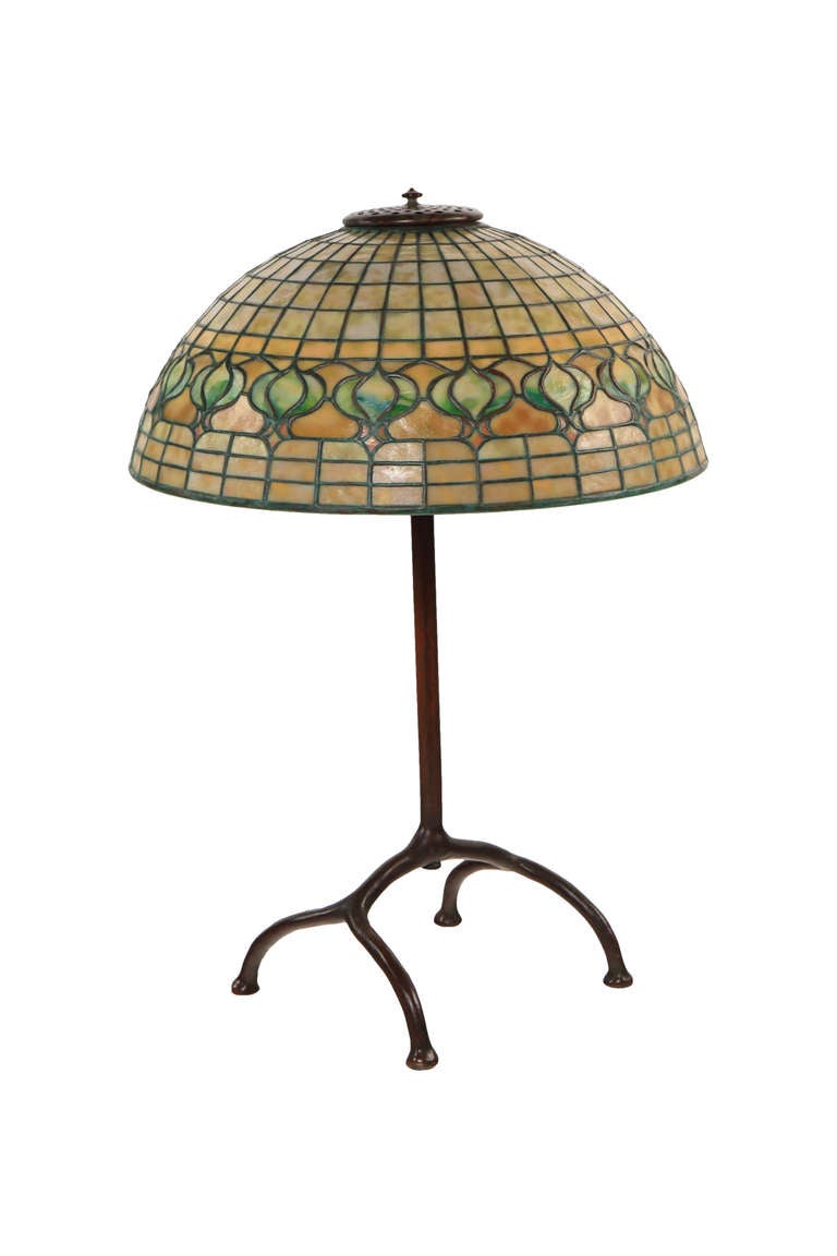 This lamp distinguishes itself from others by its extraordinary condition. The sixteen inch Pomegranate shade, signed Tiffany Studios New York 1457, retains its original patina and has a very pleasing white tinged hue when unlit transforming to a