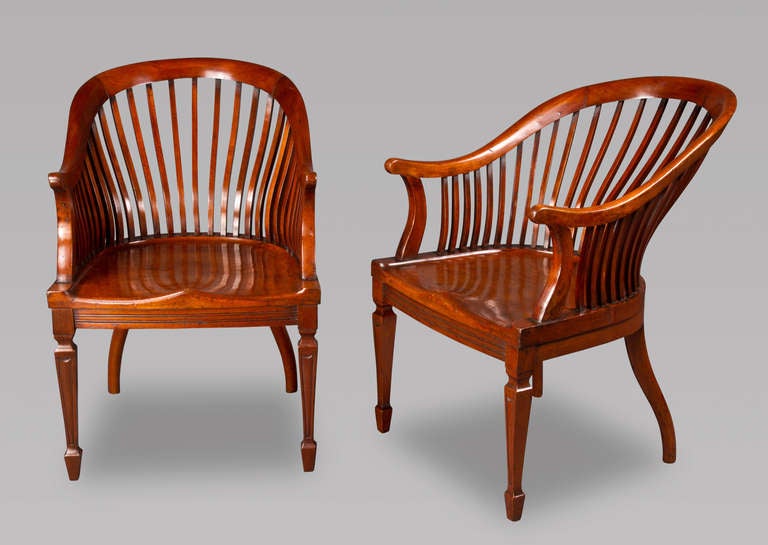 Rarely does one see a pair of chairs with such a spectacular profile. Stylish to the extreme, the chairs would have sat in the library of an Edwardian mansion or in the hallway where the owner donned his riding boots before the hunt. Whatever the