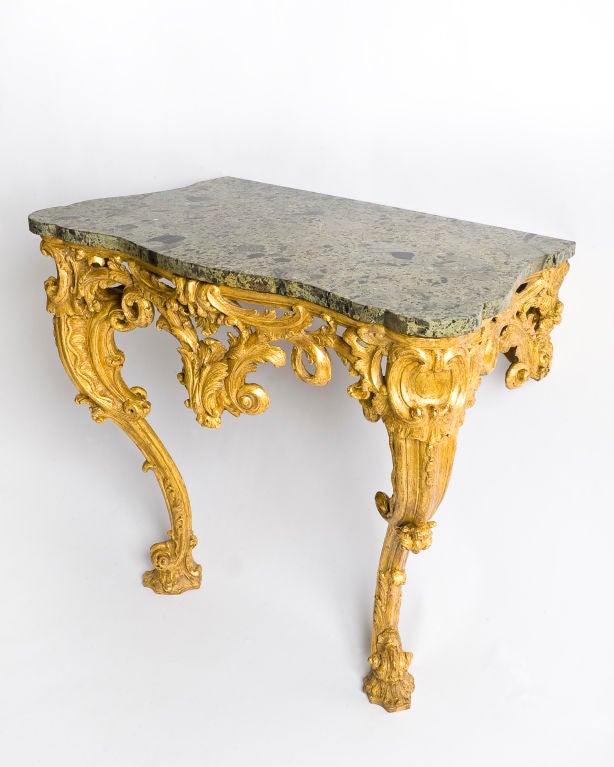 Particularly good example of a Chippendale period giltwood console table.The top is a pleasing mottled verde anticomarble above a pierced foliate and C-scroll frieze raised on cabriole legs similarly decorated and terminating in leafy-scroll toes.