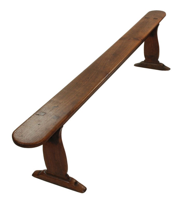 Each with rounded rectangular seat, on baluster shaped trestle supports and downswept block feet