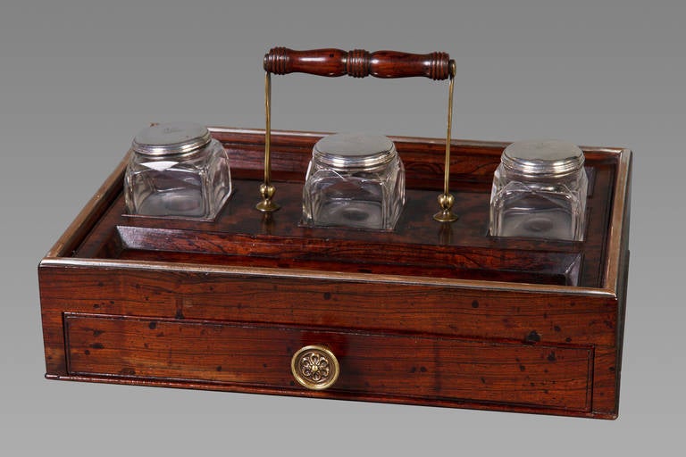 A very fine quality goncalo alves and brass mounted portable standish (inkstand) with three original silver mounted glass inkwells hallmarked for 1817 by the leading London maker Edwards. Each silver cap is engraved with the crest of a lion passant