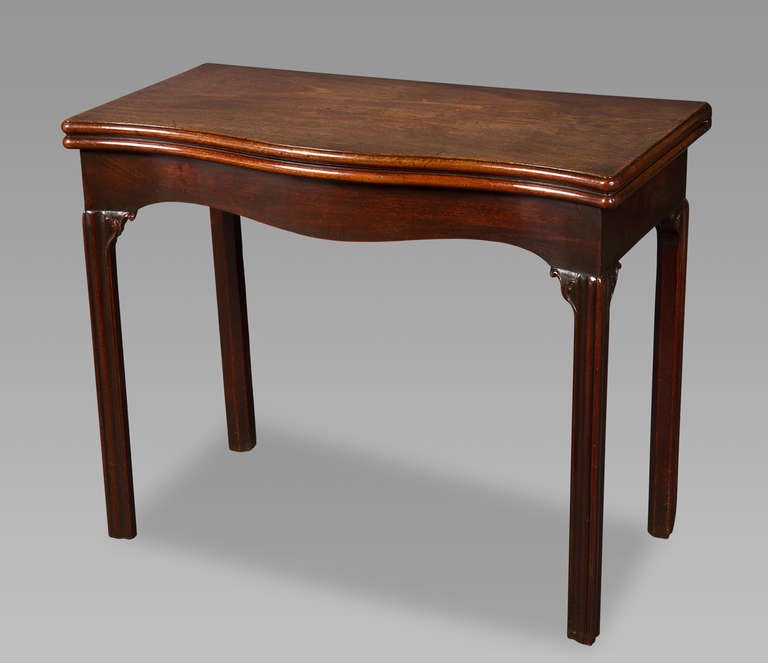 With a serpentine outline to the front and a gateleg action, this this games table retains its superb original depth of color and finish. It is very rare to find English furniture in such an untouched state.