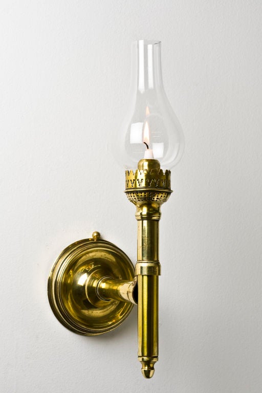 French brass candle lamp that converts into a bracket to be attached to a wall. The lamp stamped to the internal tube with the maker's details AC Btd S.G.G Paris as well as Brevet or patent.