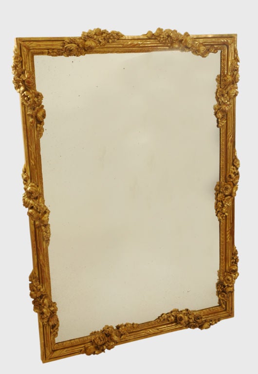 Carved in white oak and water gilded this frame probably surrounded a French pastoral painting, before it was converted to a mirror. Whatever its origins this frame exhibits particularly fine carving.