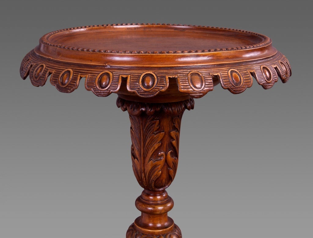 Crafted in fruitwood, each with a molded top with lappet frieze on carved baluster support terminating in carved s-scrolled tripod feet. The fact that the primary wood is fruitwood and that there are variations to the carving indicates that they