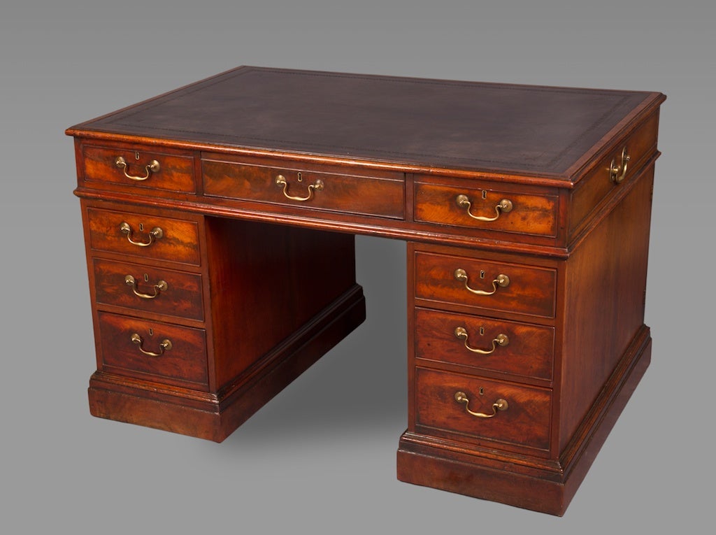 Inset black leather above an arrangement of nine drawers, the opposing side with cupboard doors, raised on plinths with castors. Two drawers stamped A. SOLOMON 59 GT QUEEN ST. Abraham Solomon was a London furniture broker and antique dealer