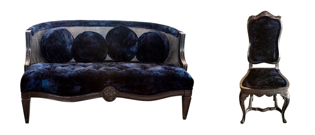 Rare vintage hi-gloss charcoal settee with caning & navy blue crushed velvet seating and cushions. Size: 48W x 26H x 24D. Also see accompanying boudoir chair.