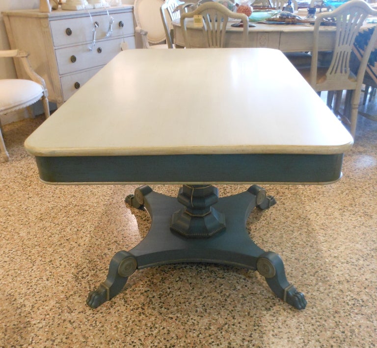 19th Century Danish antique painted library table with a central column; has a base with four rounded lion feet.