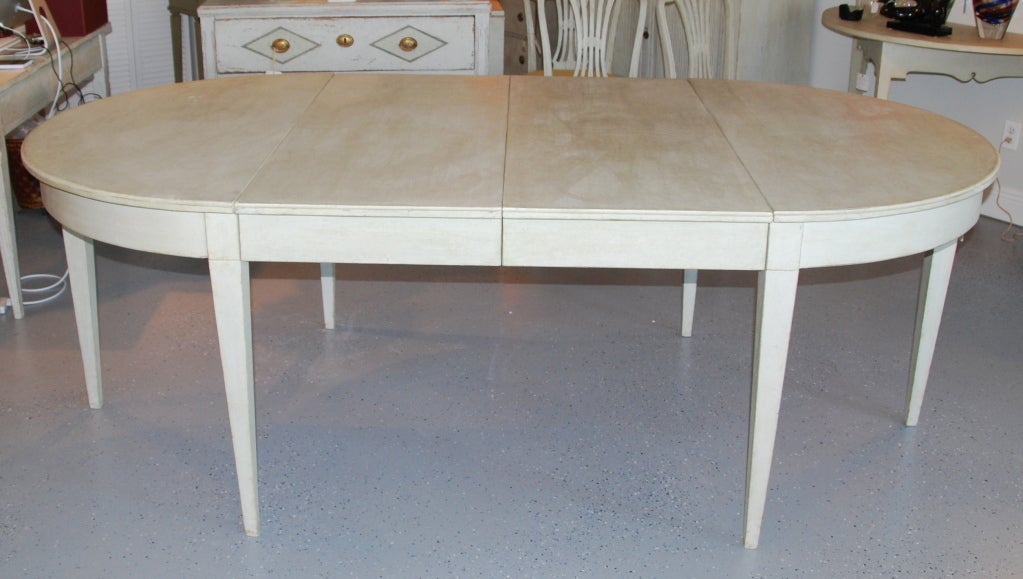 Very elegant and simple dining table with two leaves added later. Can be used round or with one or two leaves. Refreshed paint in an oyster white with greenish undertones.