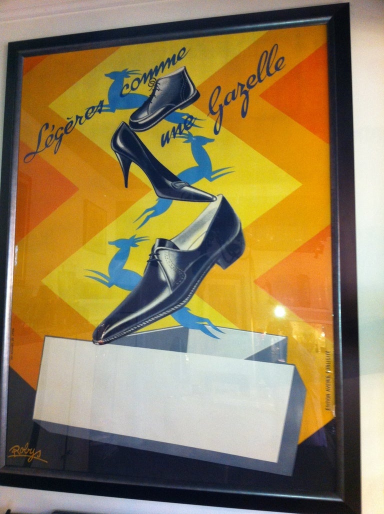 Affiche publicitaire de chaussures ''Robys'' estampillée avec boîte cadeau et chaussures et Gazelles sautant hors de celle-ci ! Encadrement en noir et feuille d'argent Cadre, vers 1940, français.