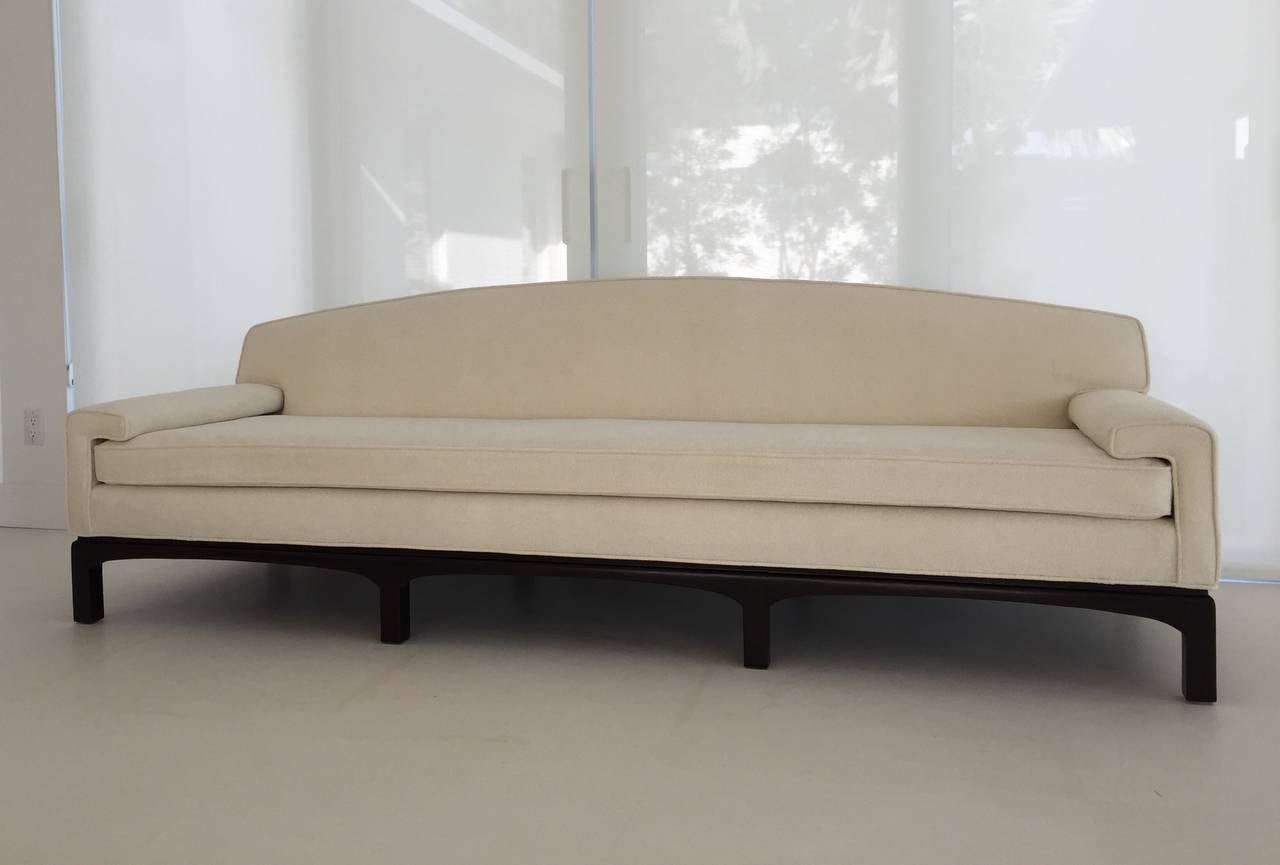 Elegant B. Altman Co original tag Urban for B Altman custom-made long sofa. One cushion with curved low arm design and dark walnut original wooden base in crème nub chenille fabric.
