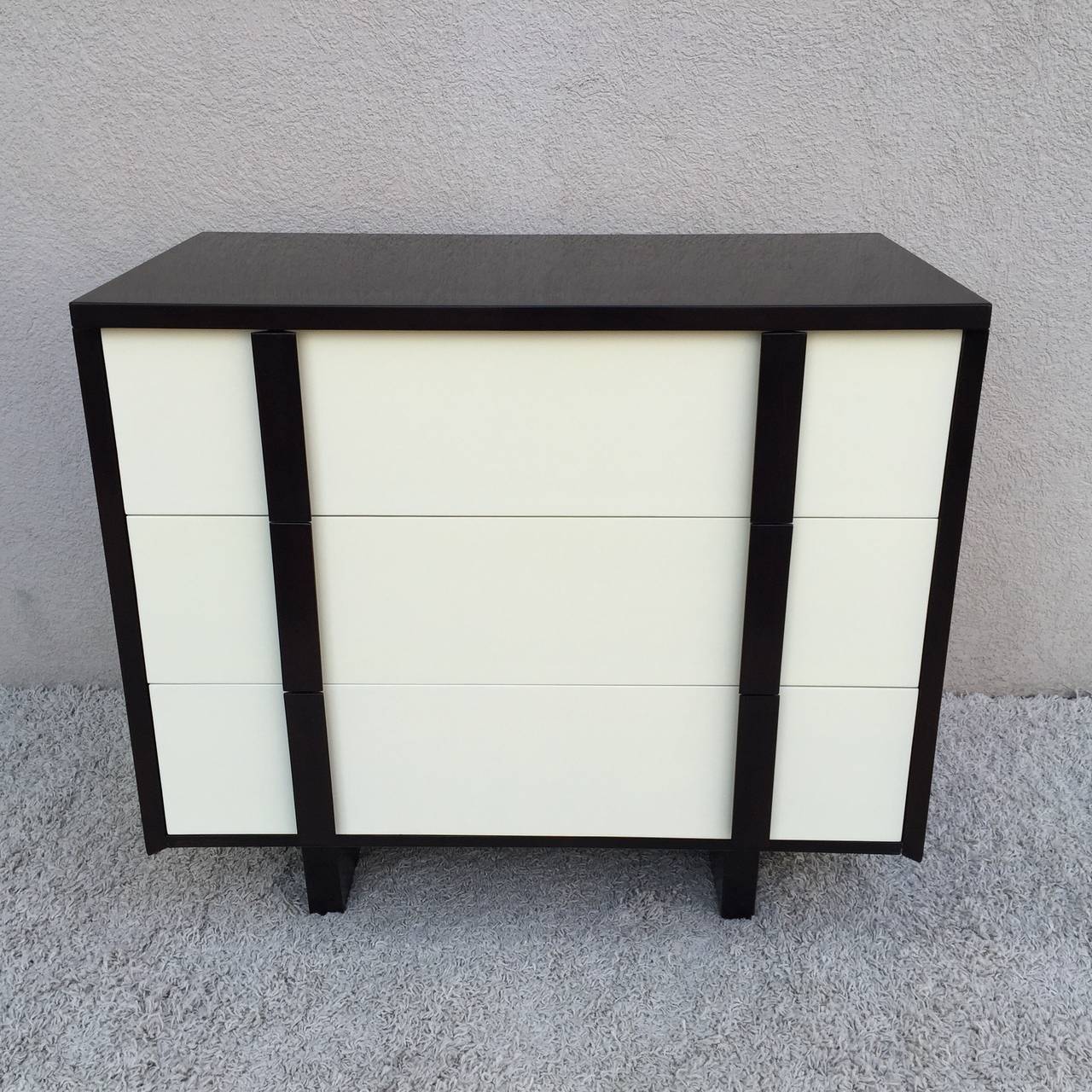 Pair of Paul Laszlo dark walnut off-white lacquered chest of draws with dark walnut pulls, hand rubbed finish.