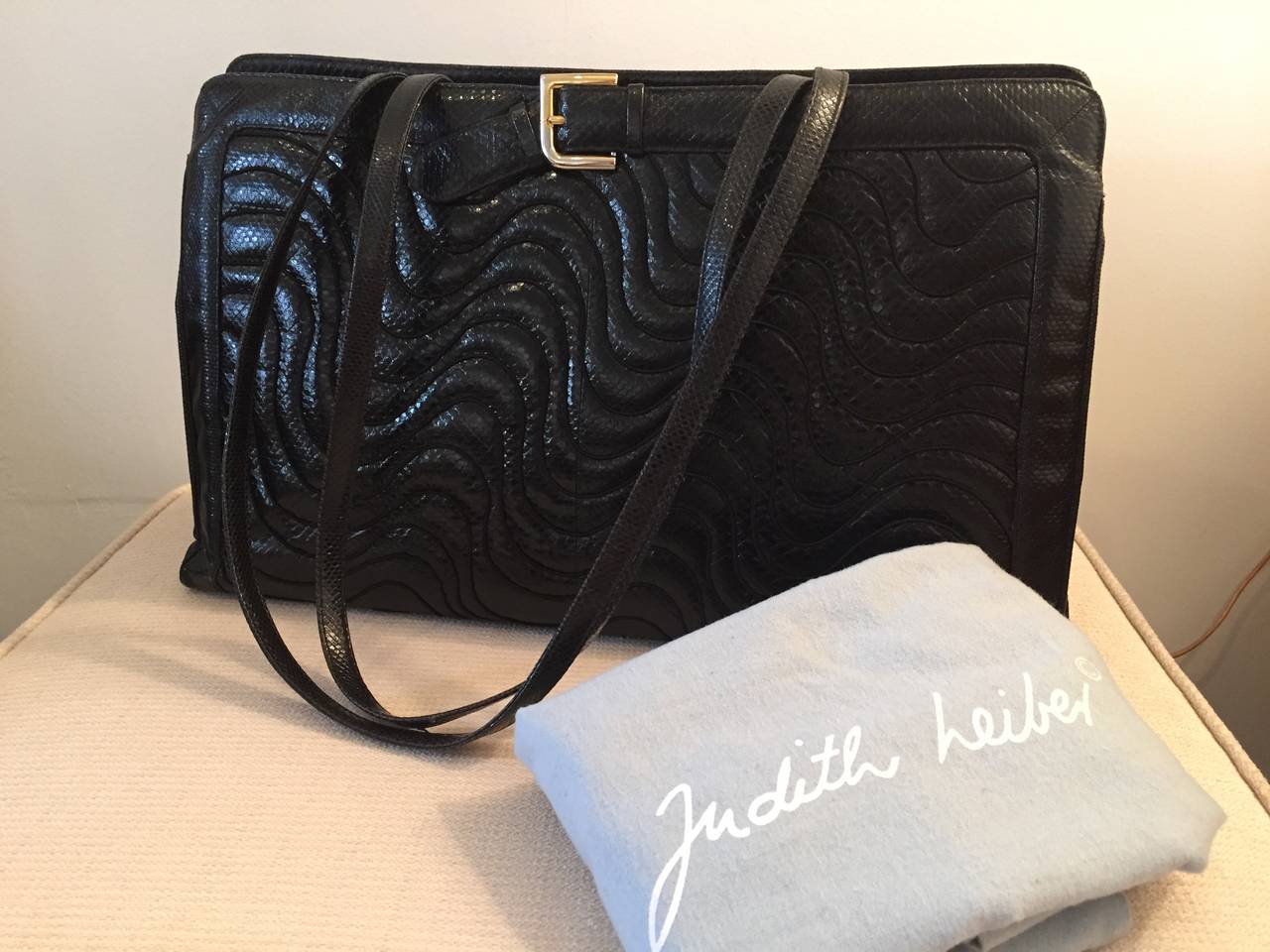 Extra-large Judith Leiber quilted snakeskin pocketbook with two long shoulder straps and buckle Front Design, in pristine condition with box and felt cover.