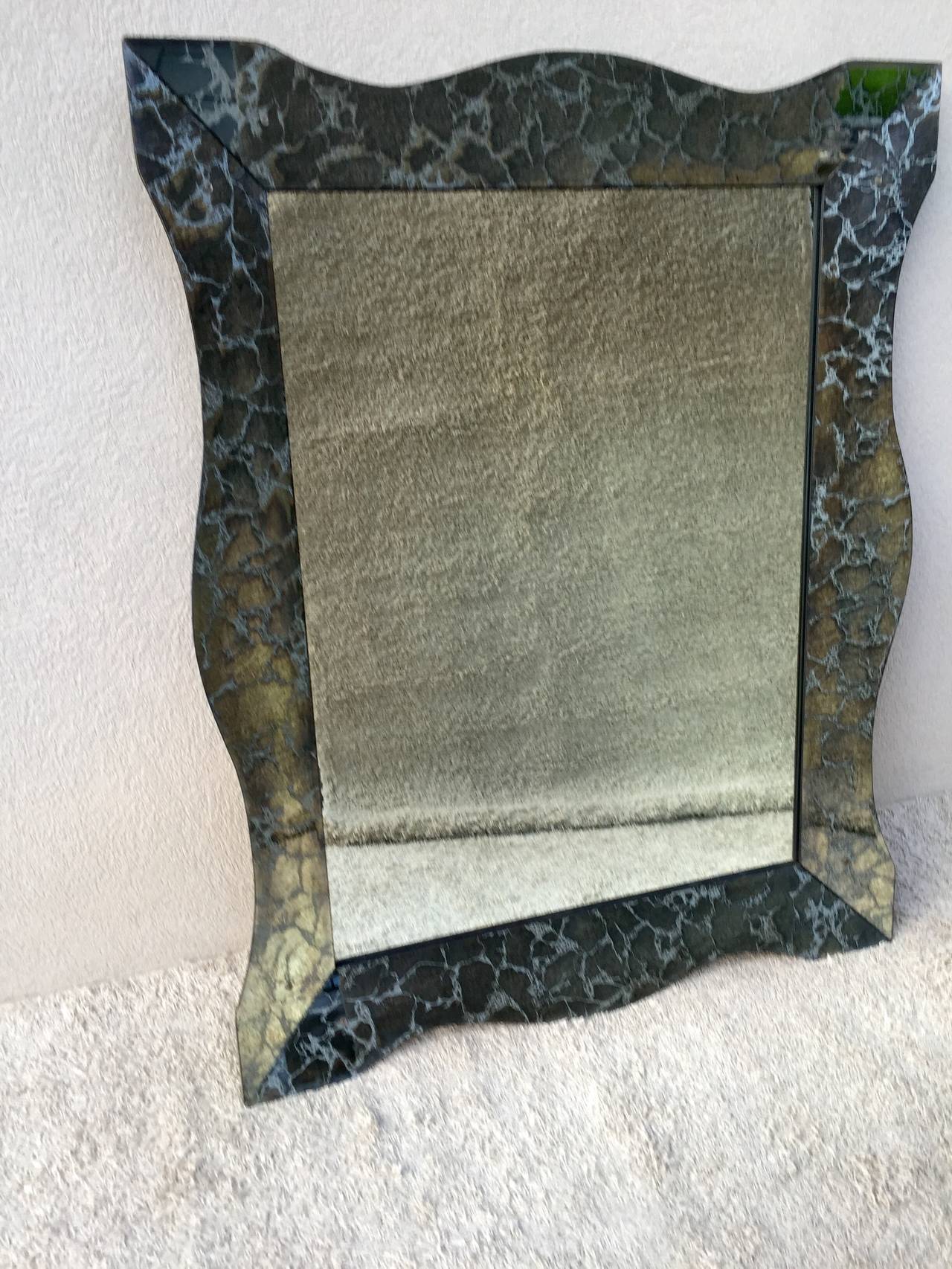 Very large Hollywood Regency smoked charcoal silver vein beveled mirror. Beautiful curved lines and condition.