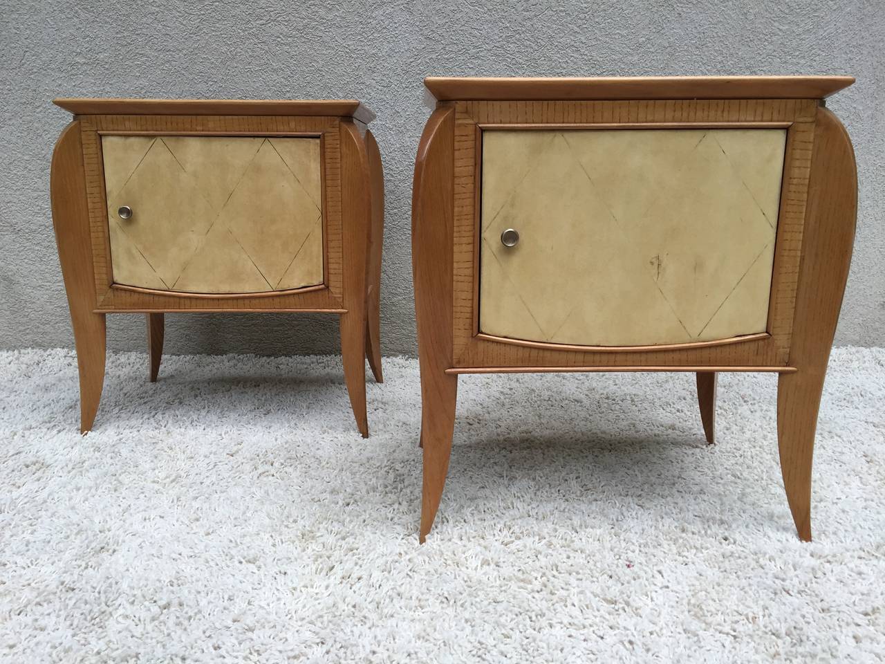 Pair of French petite parchment sycamore or zebra wood nightstands or end tables. Lovely bronze pulls, with cabinet compartment. In the style of Jules Leleu.