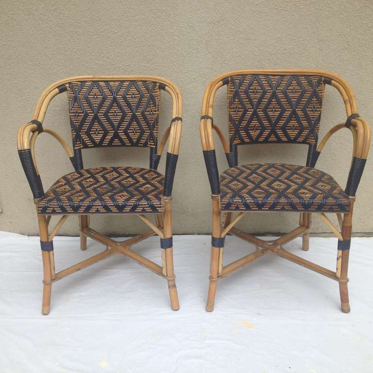French Drucker Rattan set Handmade Lovely Blue and natural Weaved ,The makers of the titanic Lounge and deck Chairs Parisian Handmade circa 1960's set in very fine condition.the set consists of dinning glass to table with 4 armless chairs and two